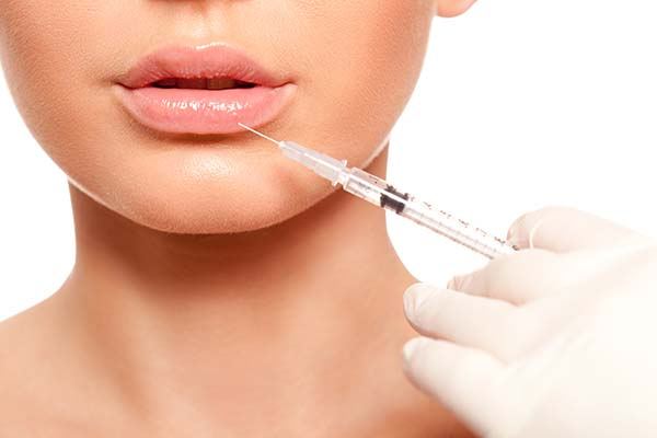 Lip area being treated with a fine injection