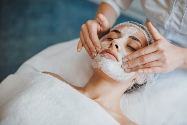 Client relaxing during a facial peel treatment